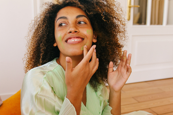 Woman in Loungewear Applying Skincare