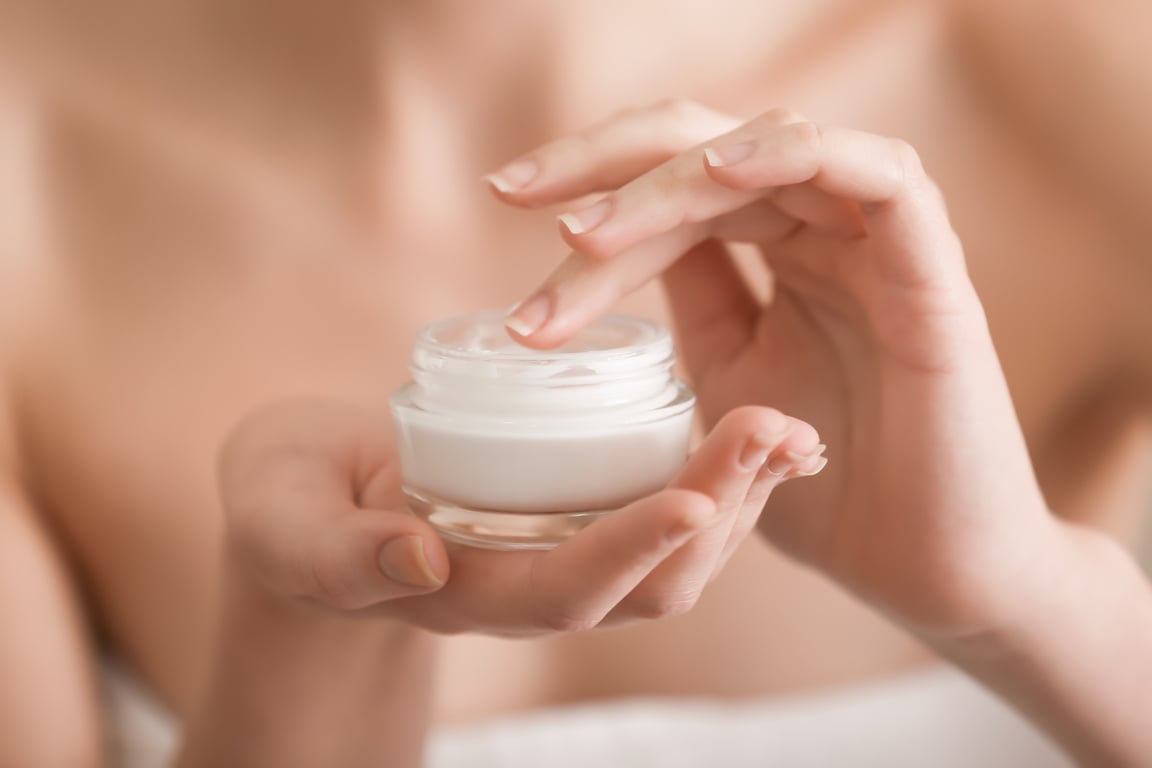 Young Woman with Jar of Hand Cream